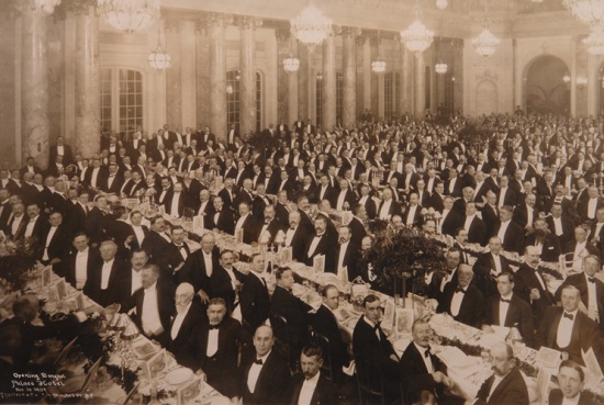 a large group of people in formal attire at a banquet