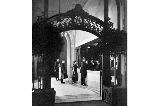 a group of people standing in front of a reception desk