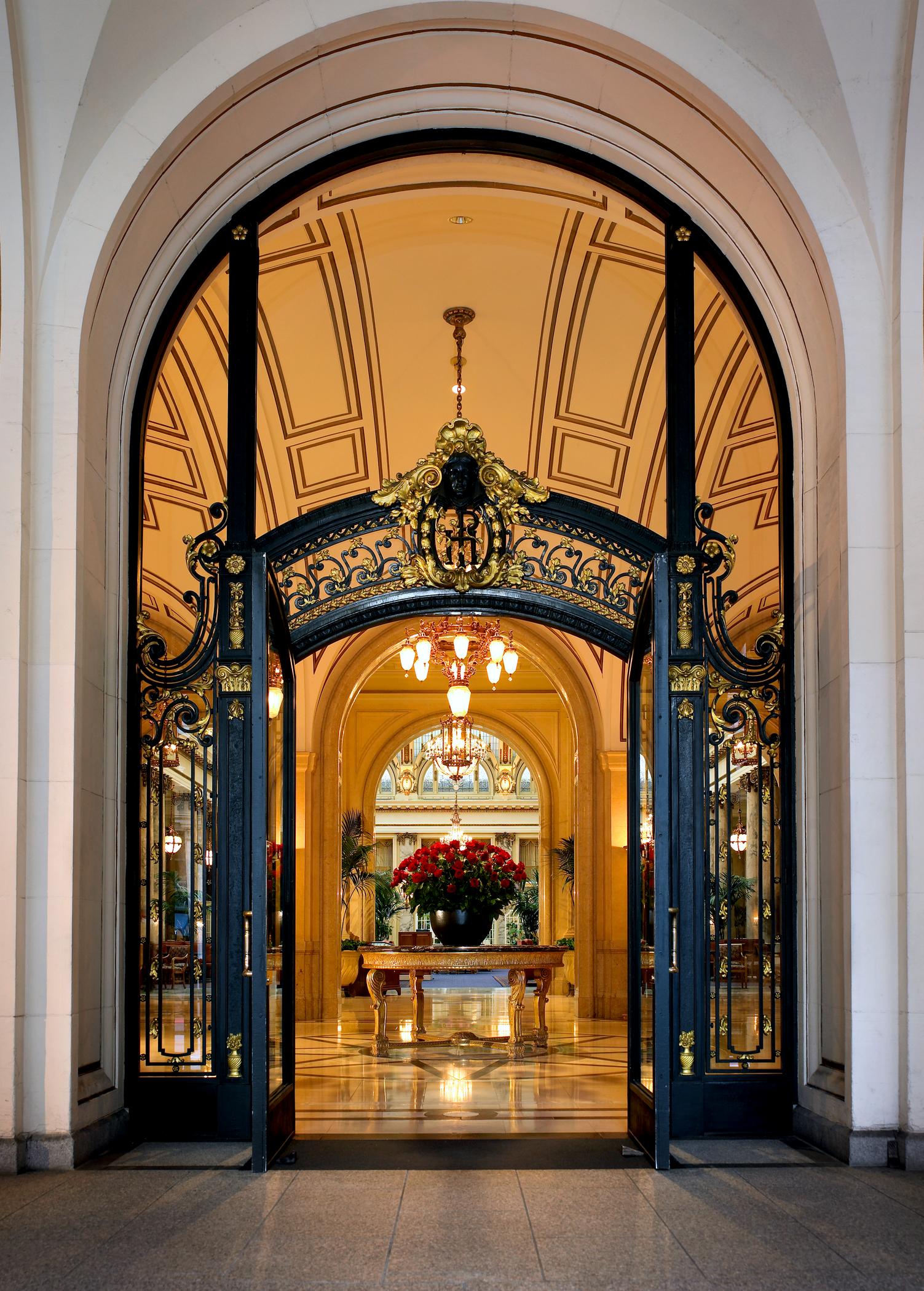 a large ornate doorway with chandeliers