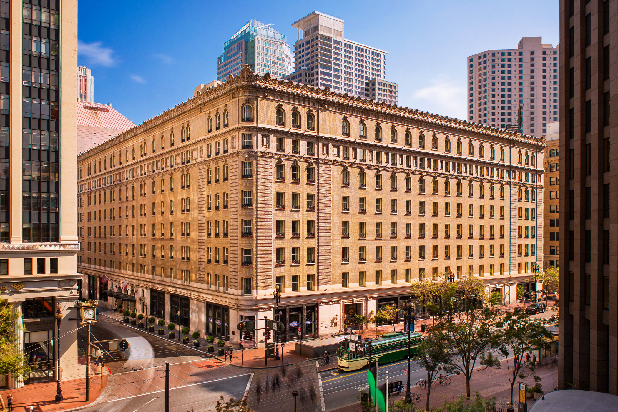 a large building with a street and a city in the background