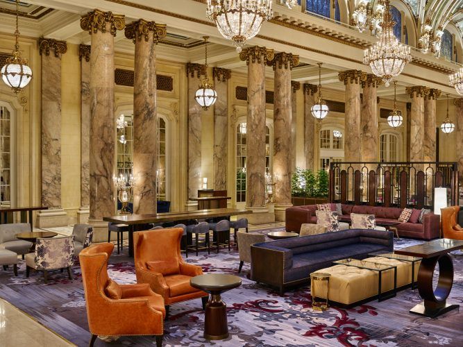 a large room with a large chandelier and chairs