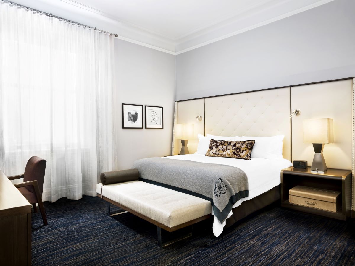 a bedroom with a bed and a chair