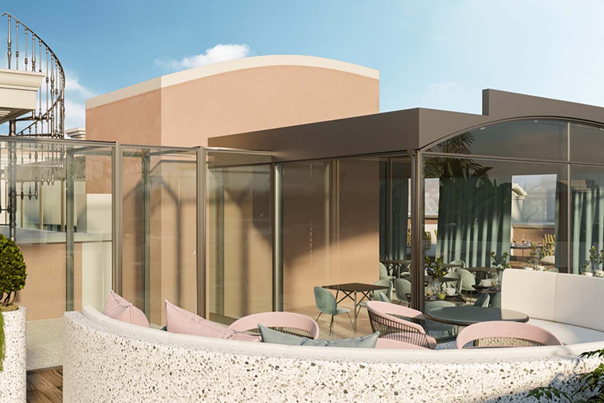 a glass wall with a table and chairs outside