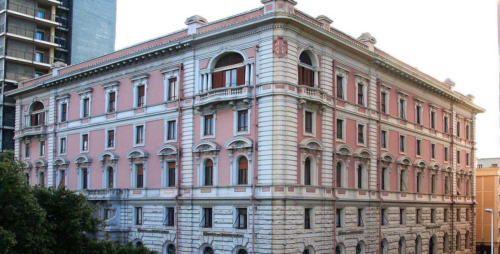 a pink building with many windows