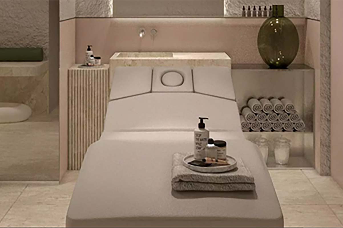 a massage table with a tray of products on it