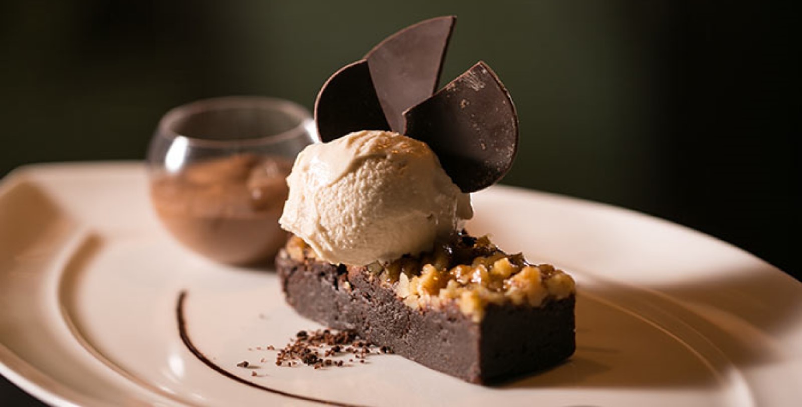 a piece of chocolate cake with a scoop of ice cream on top