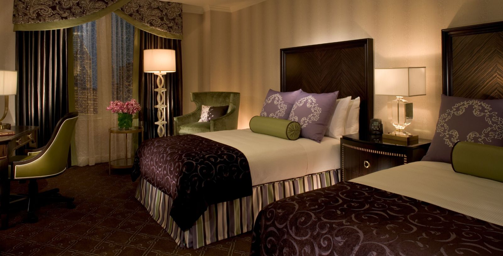 a room with a bed and chairs