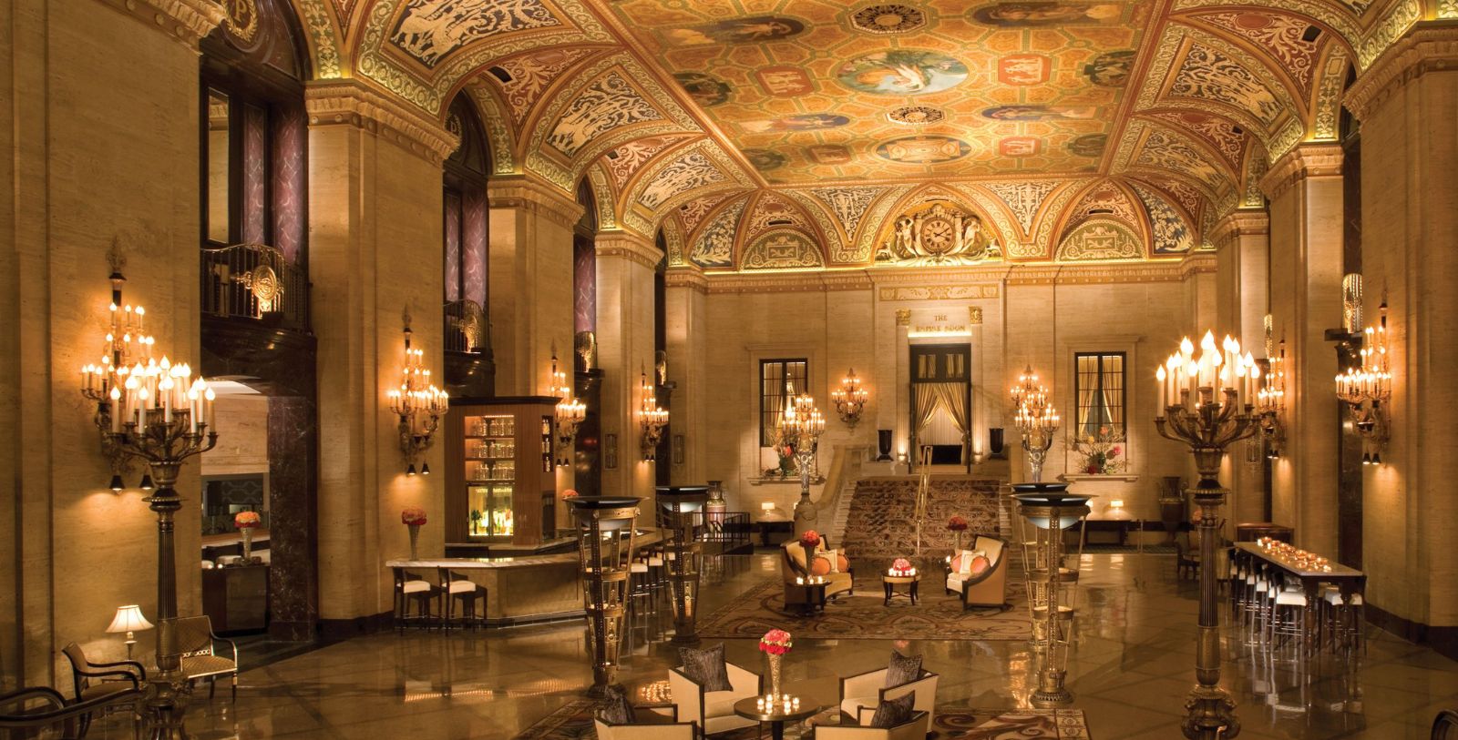 a large ornate room with chandeliers and tables