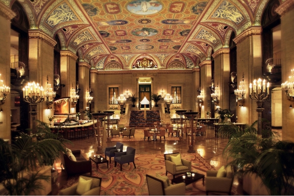 a large room with a large ceiling and a large decorated ceiling with The Palmer House Hilton in the background