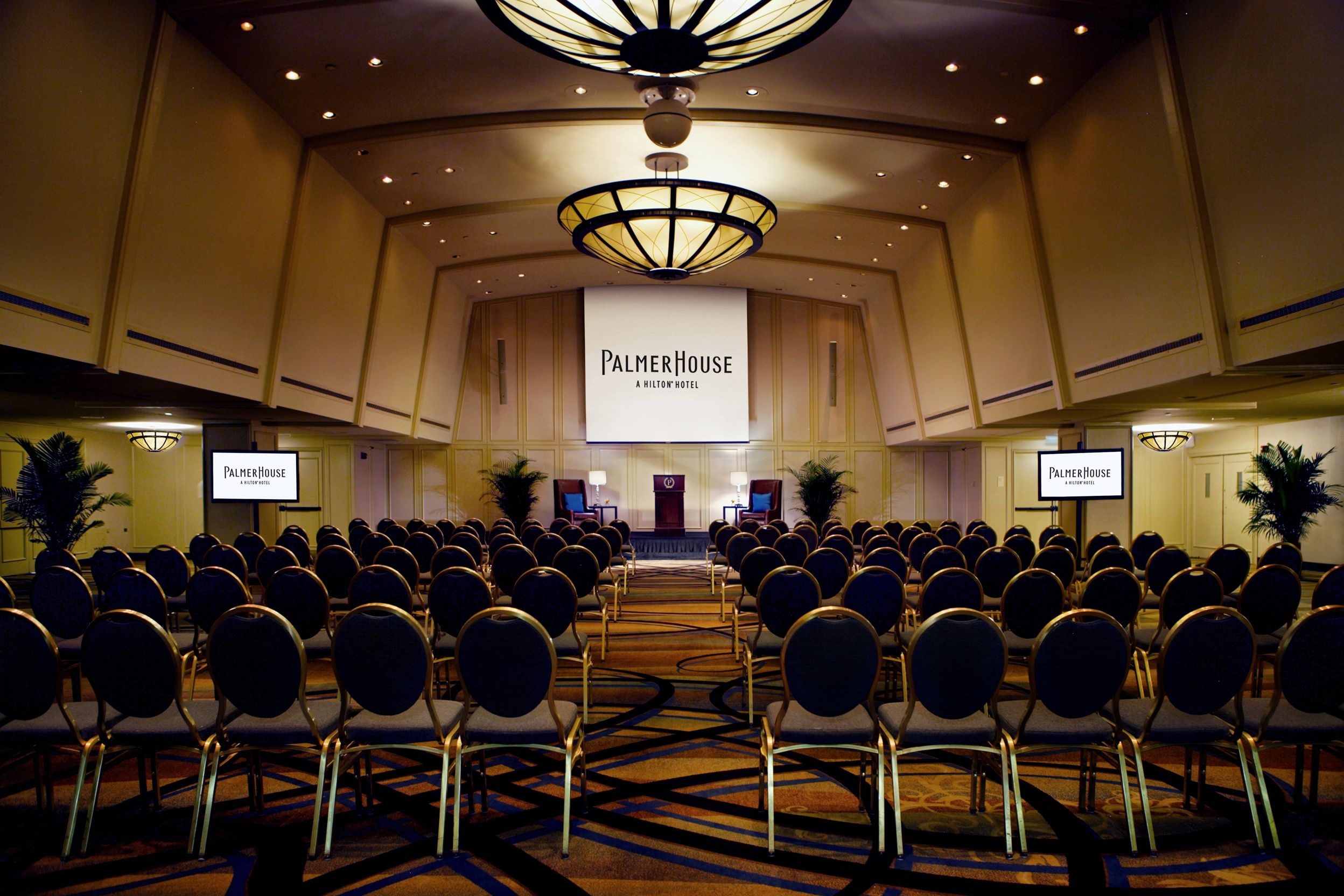 a room with chairs and a screen