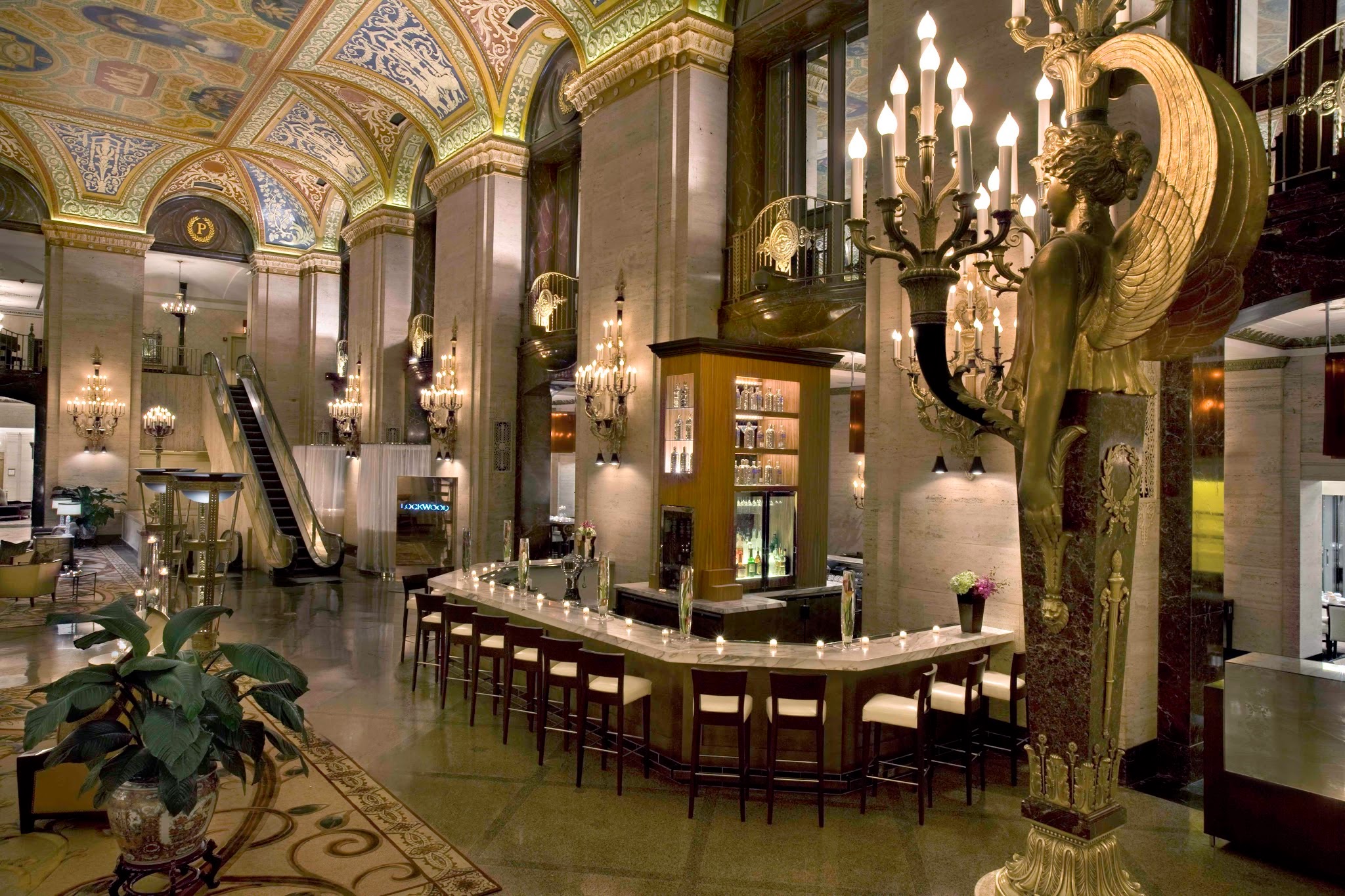 a long bar with a bar and chandeliers