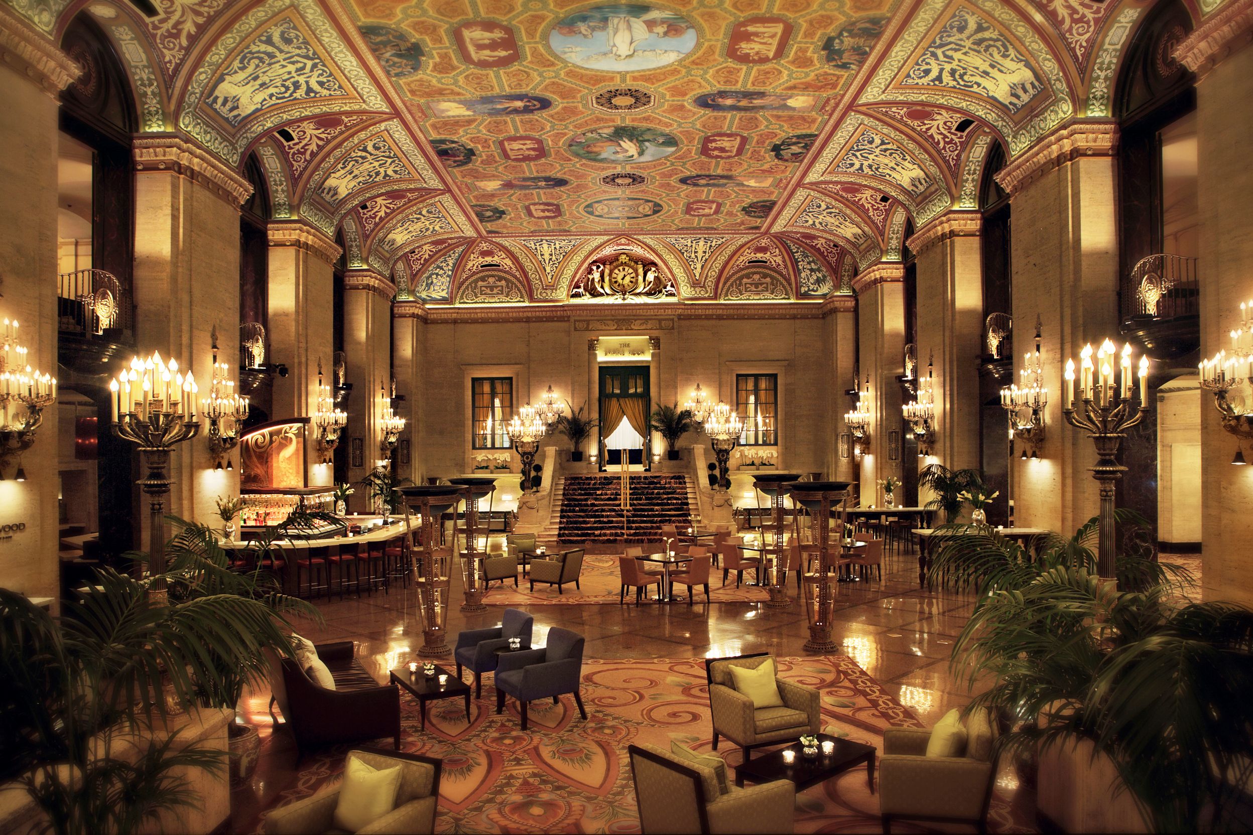 a large ornate room with a ceiling and chandeliers with The Palmer House Hilton in the background