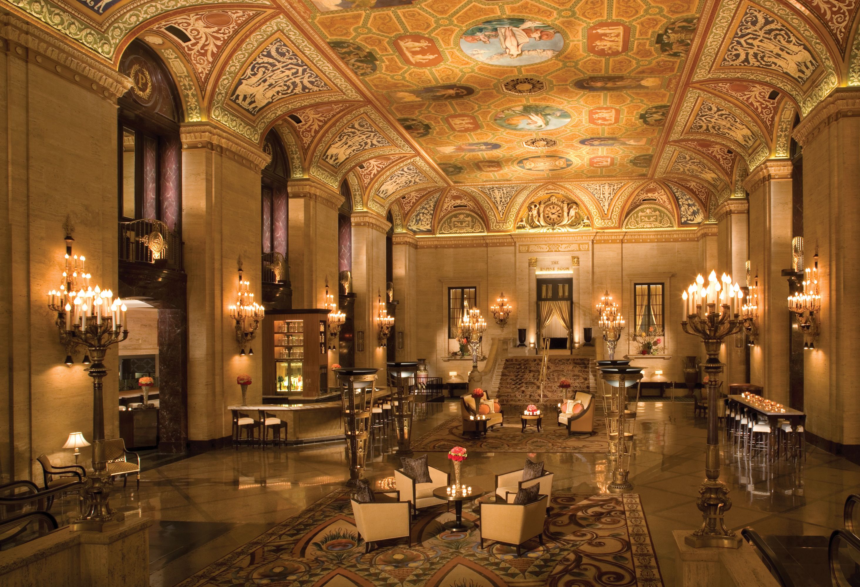 a large ornate room with chandeliers and tables with The Palmer House Hilton in the background