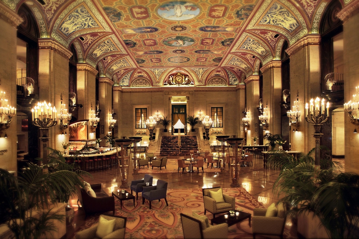 a large room with a large ceiling and a large staircase with The Palmer House Hilton in the background