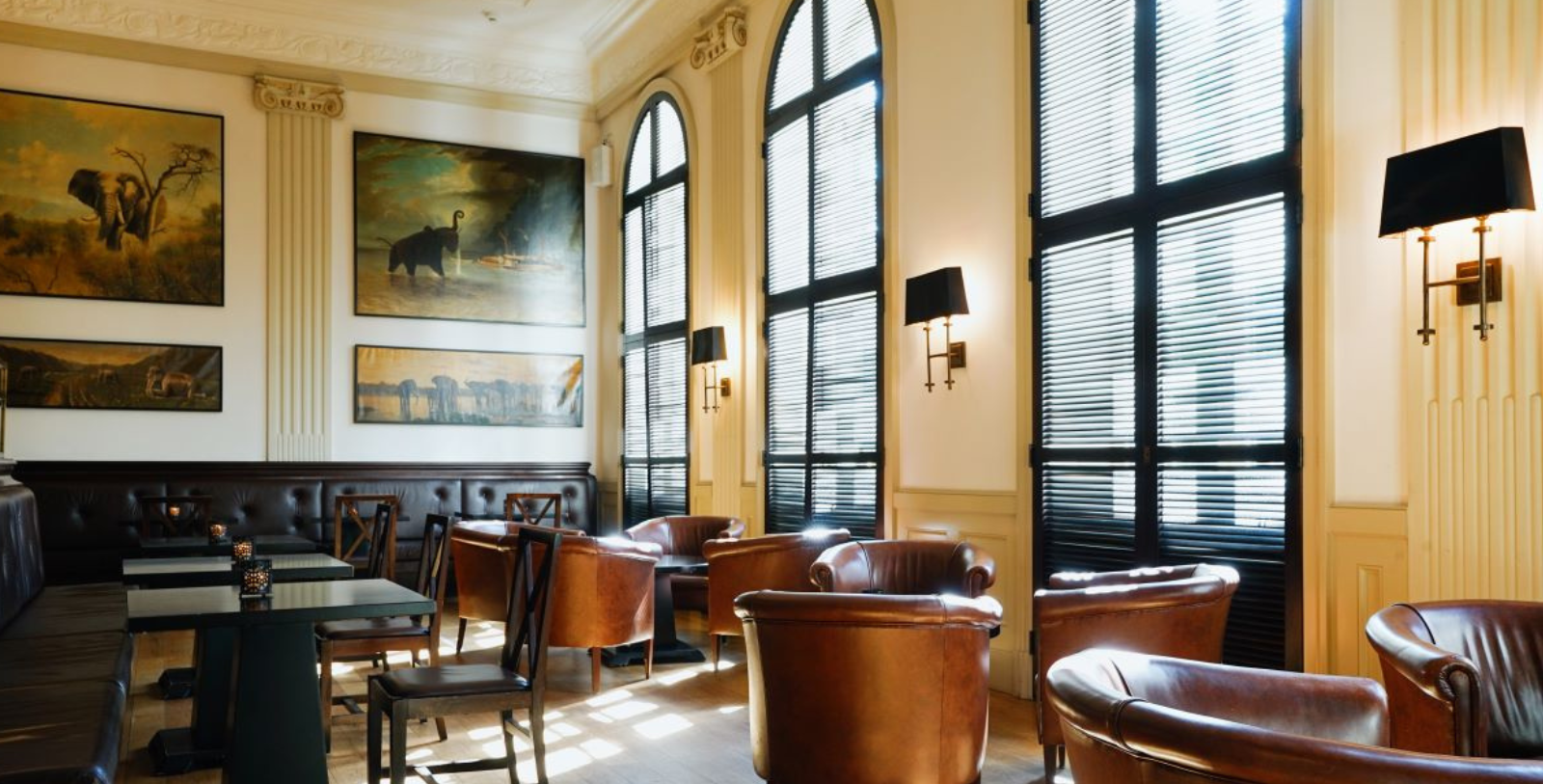 a room with leather chairs and art