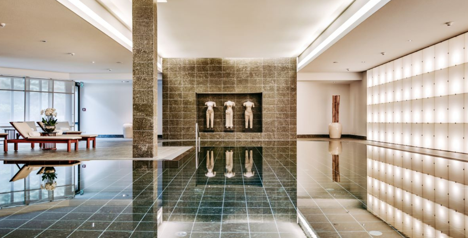 a room with a tiled floor and statues