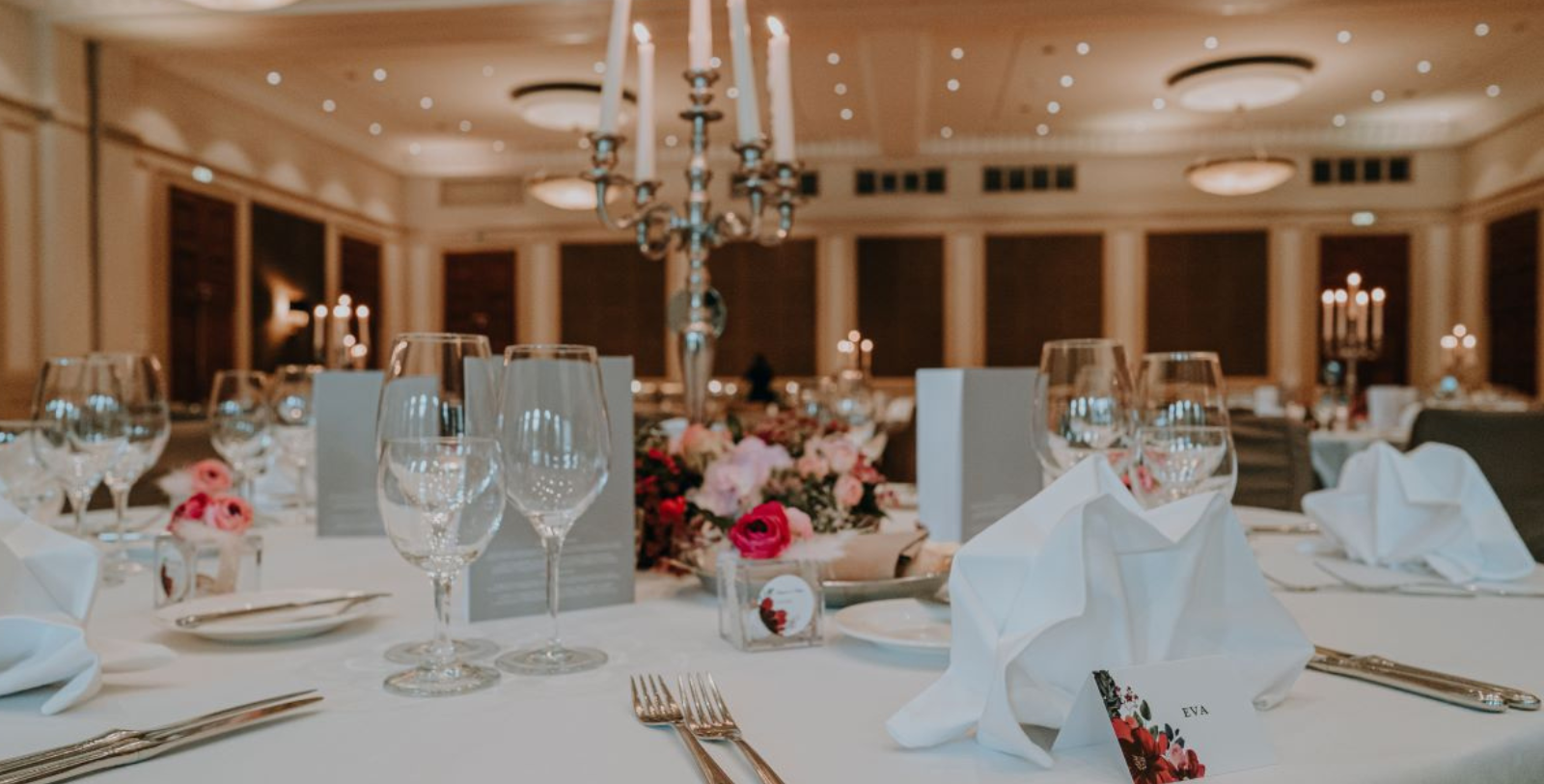 a table with silverware and candles