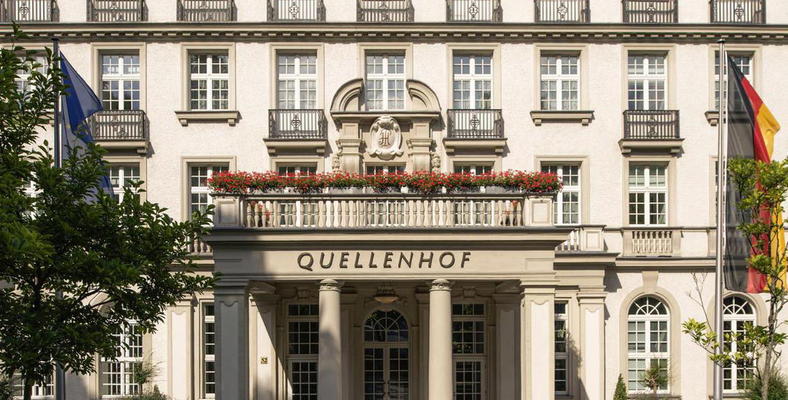a building with columns and flowers on the front