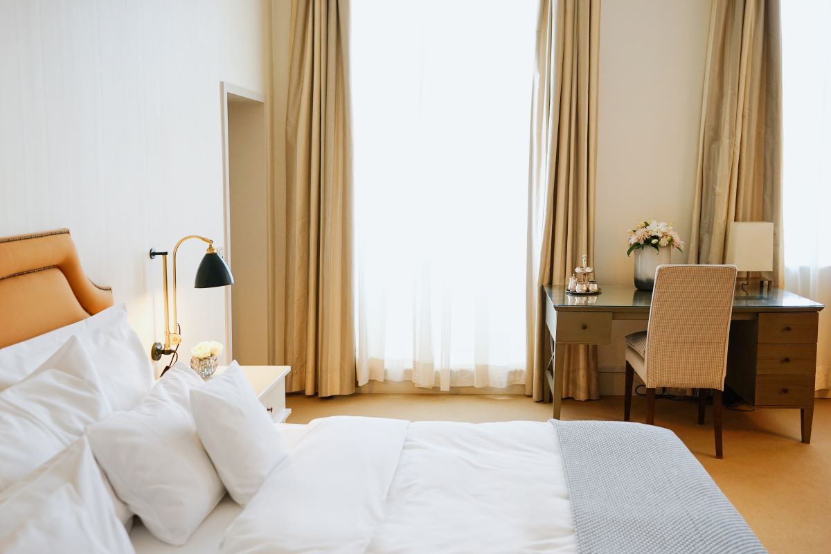 a bedroom with a desk and a lamp
