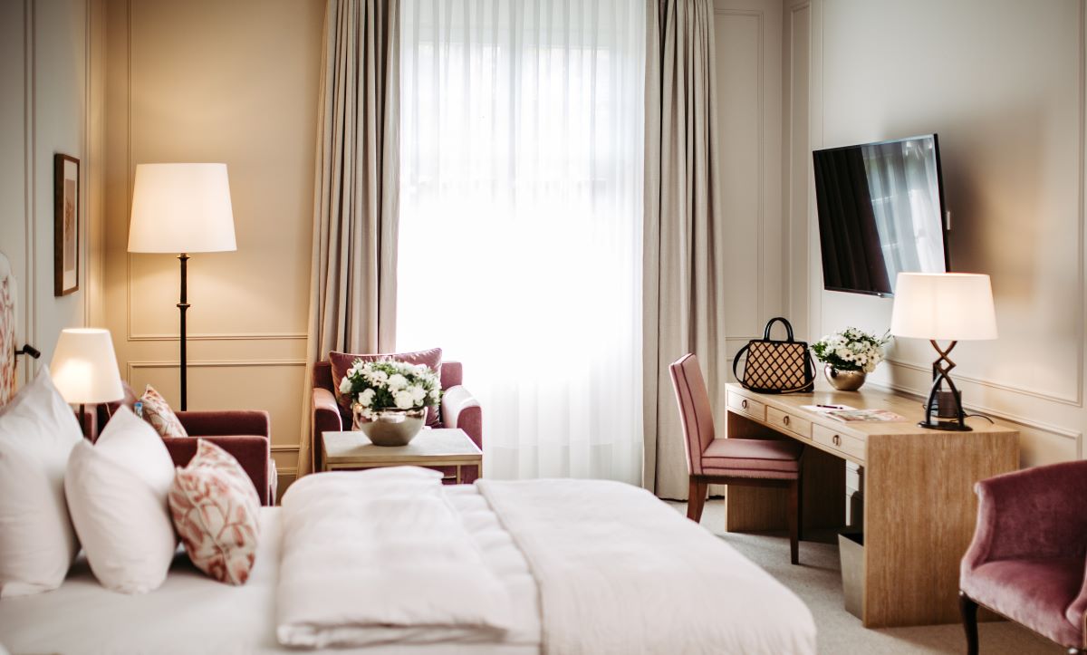 a room with a bed and a desk and chair