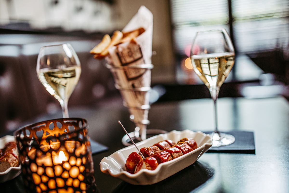 a plate of food and wine glasses on a table