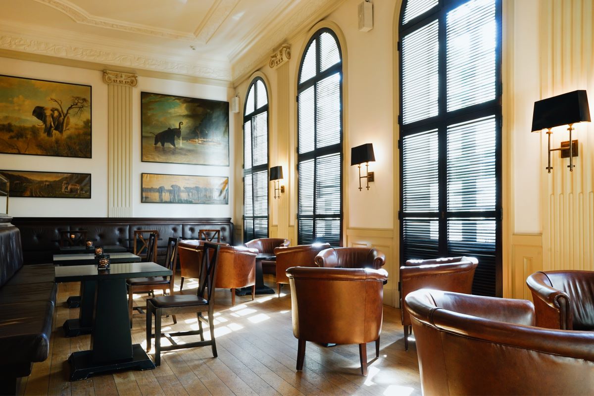 a room with brown leather chairs and a table