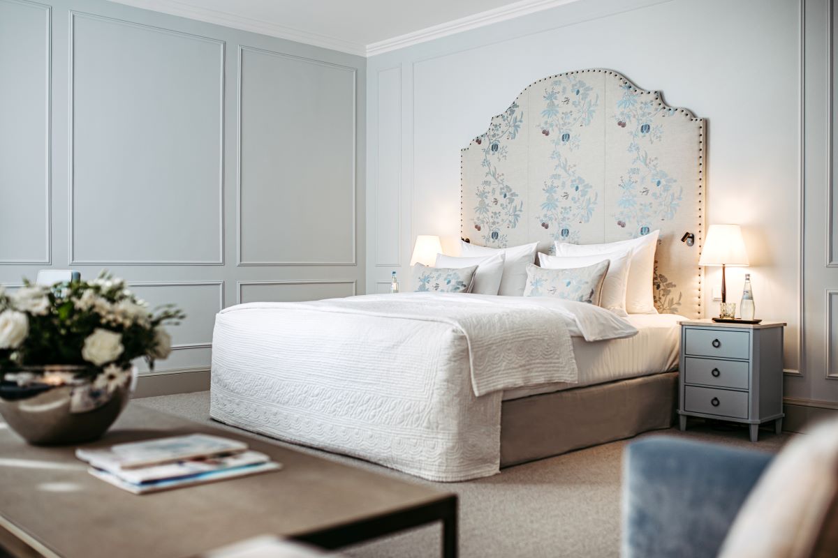 a bed with a floral headboard in a room