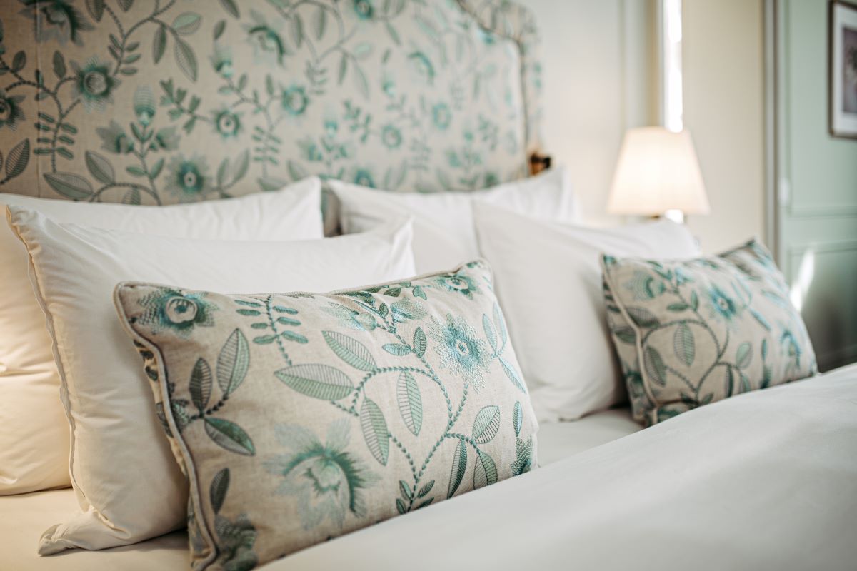 a bed with pillows and a lamp
