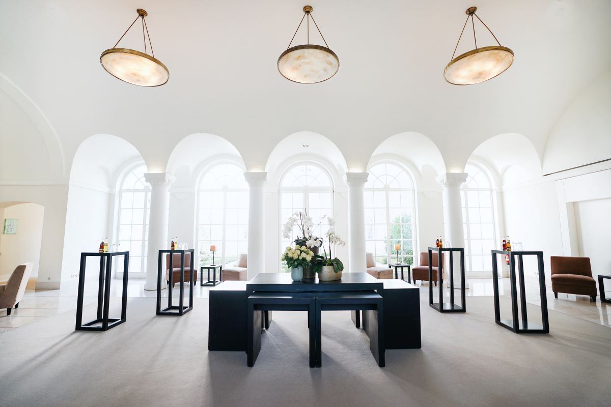 a room with white walls and arched windows
