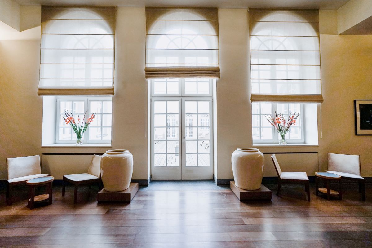 a room with large windows and chairs