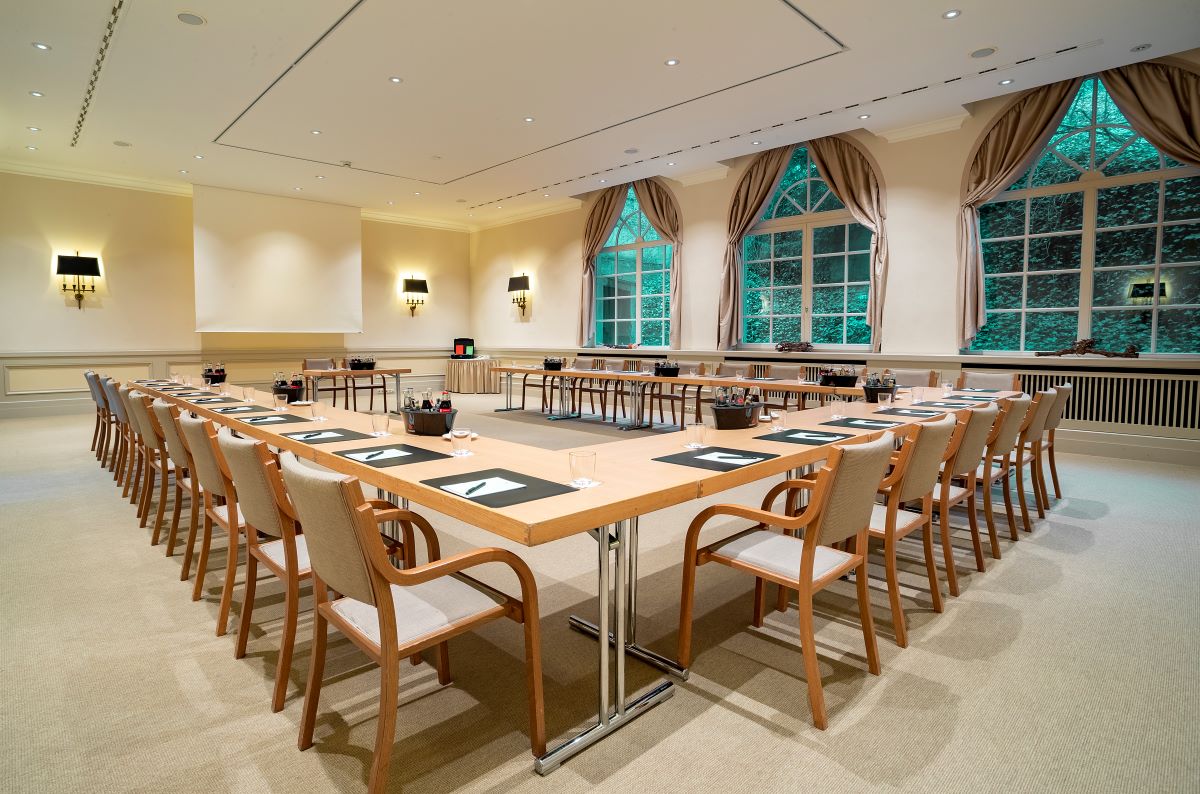 a room with a long table and chairs