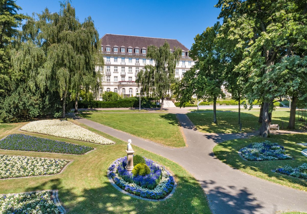 a large building with a statue in a park