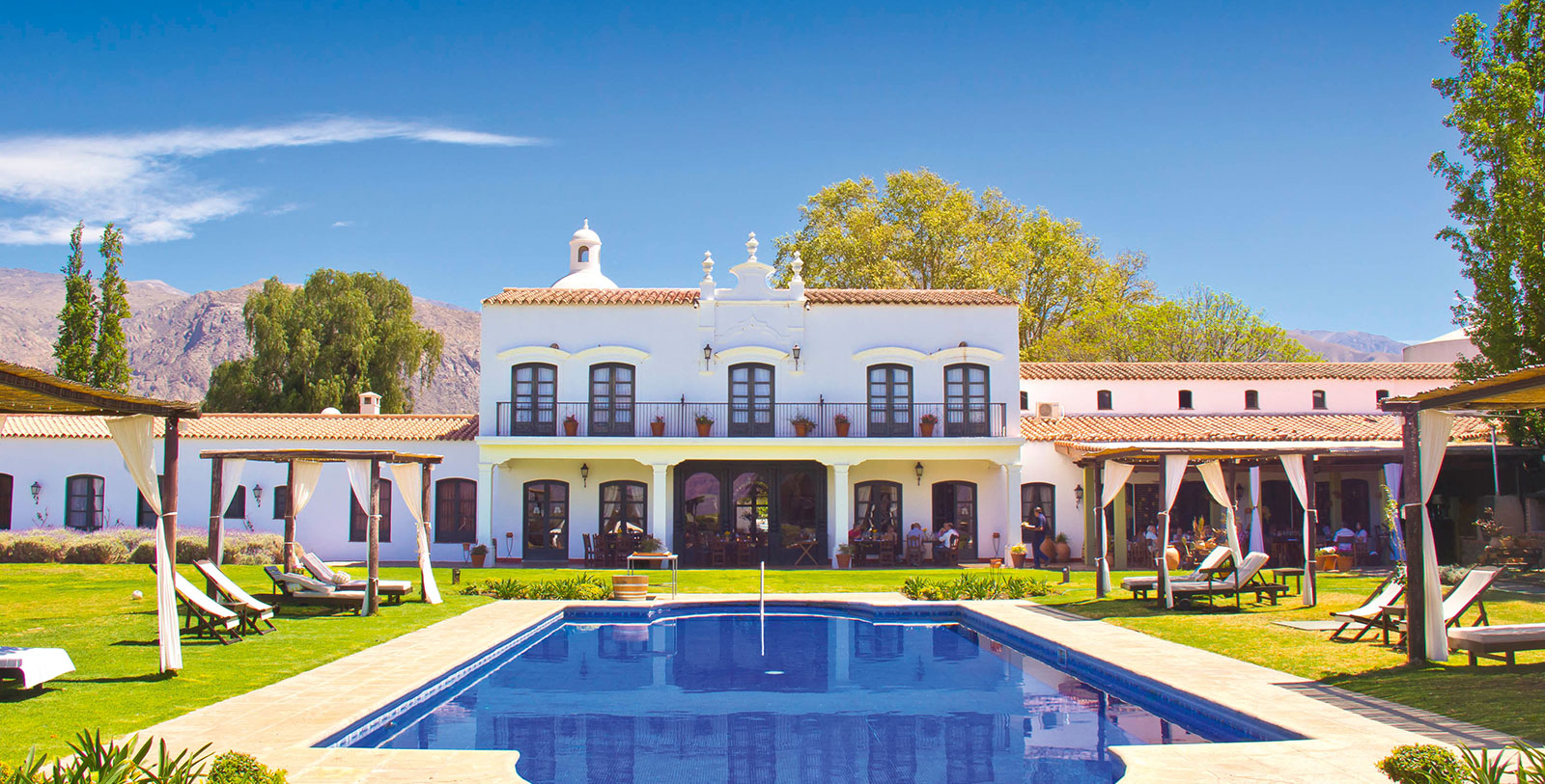 a pool in front of a white building