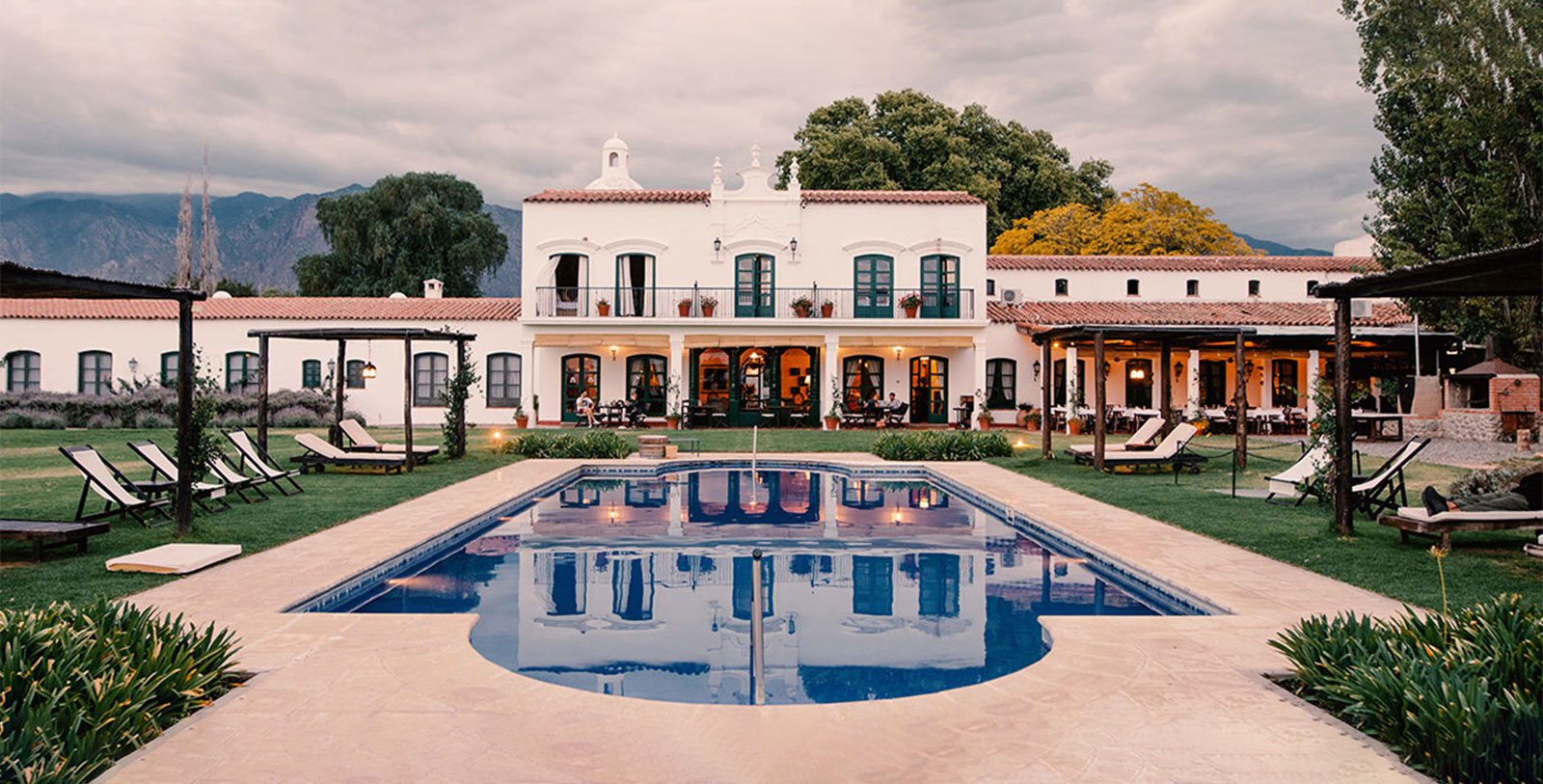 a pool in front of a white building