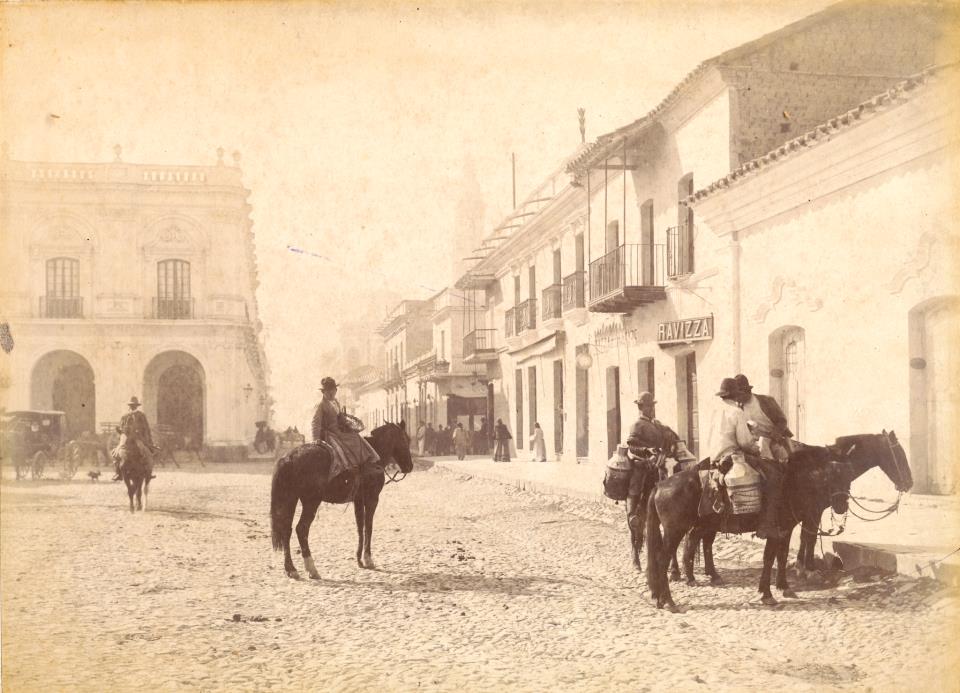 a group of people riding horses in a street