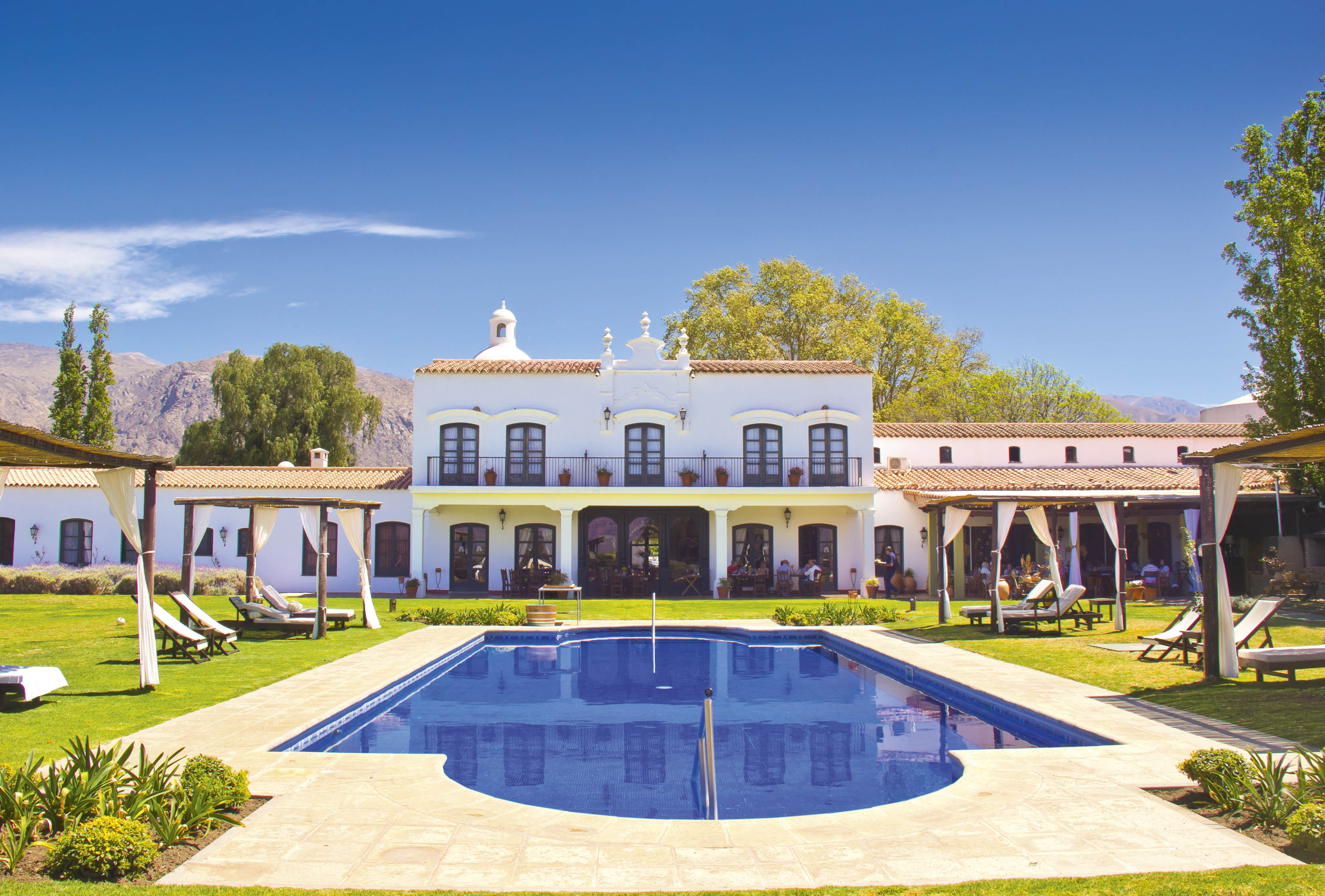 a pool in front of a white building