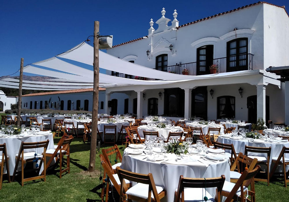 a large white building with tables and chairs