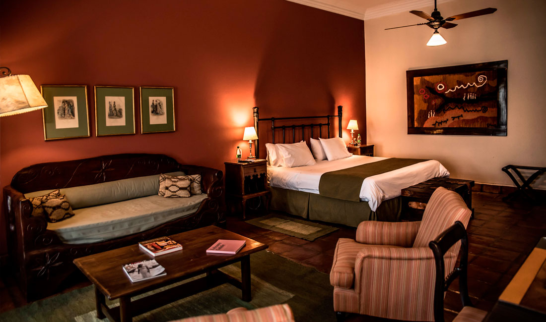 a room with a bed and couches