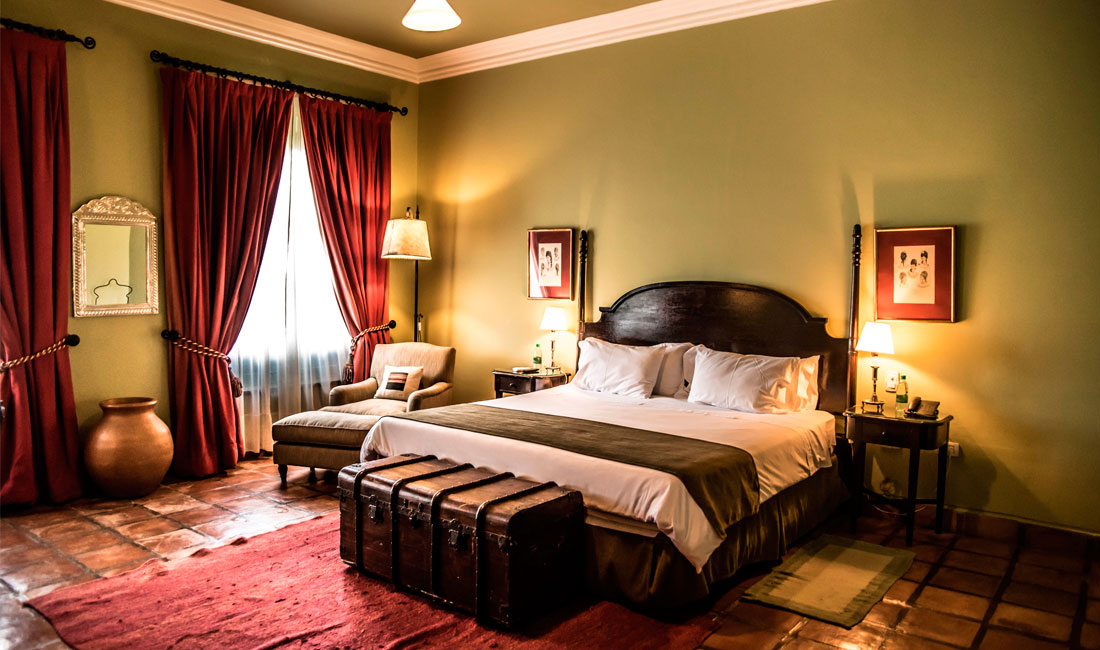 a bedroom with a bed and a chest