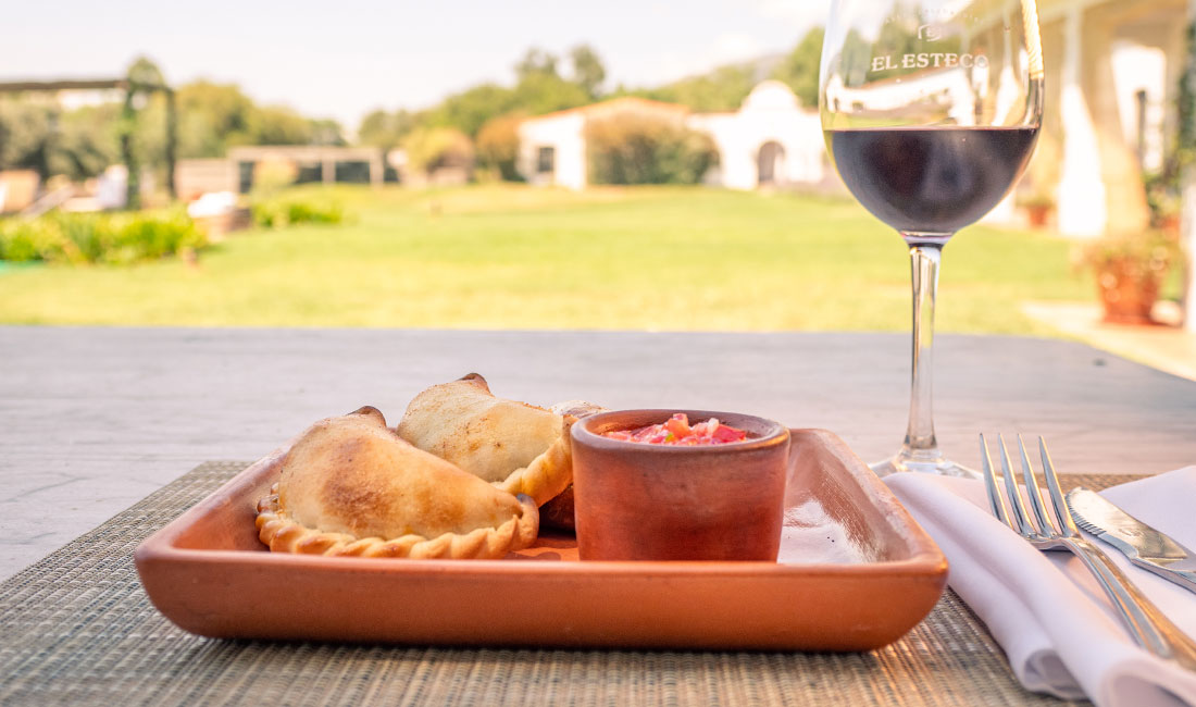 a plate of food and a glass of wine