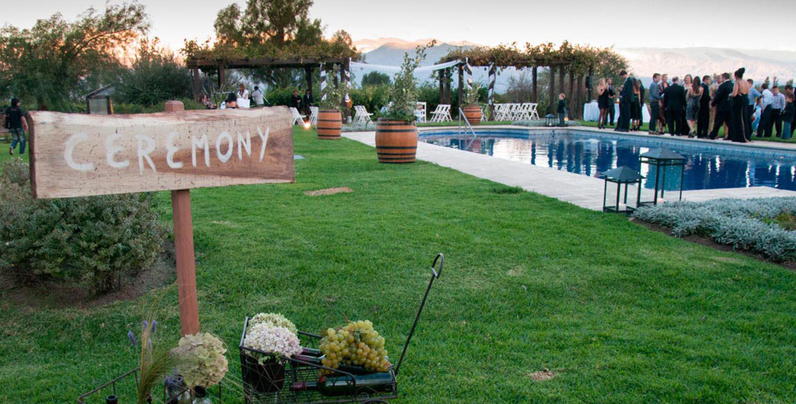 a pool with a sign and a couple of people in the background