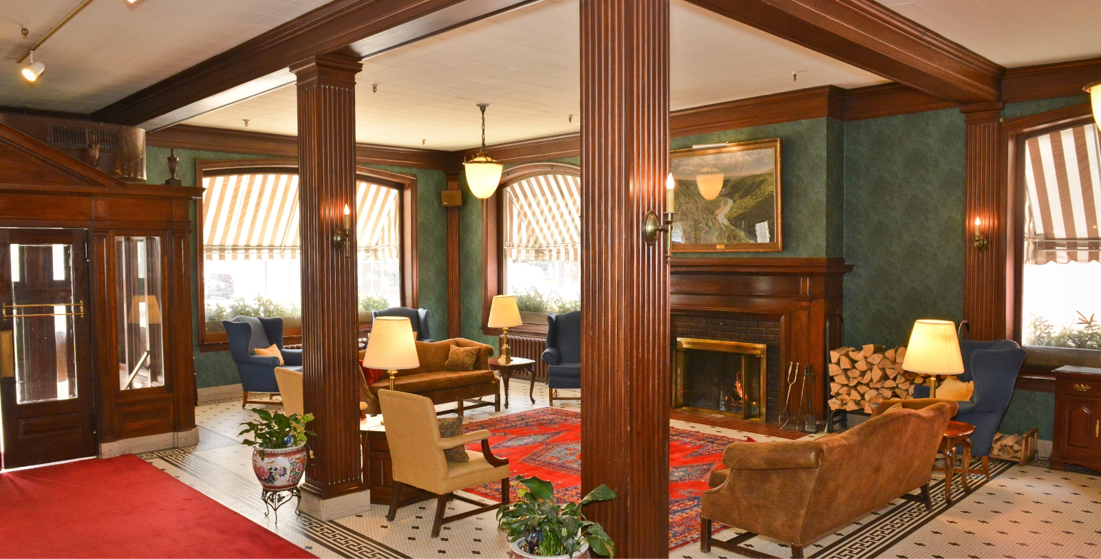 a room with a fireplace and chairs