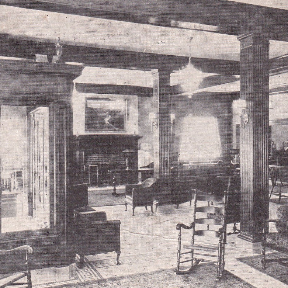 a room with a fireplace and chairs
