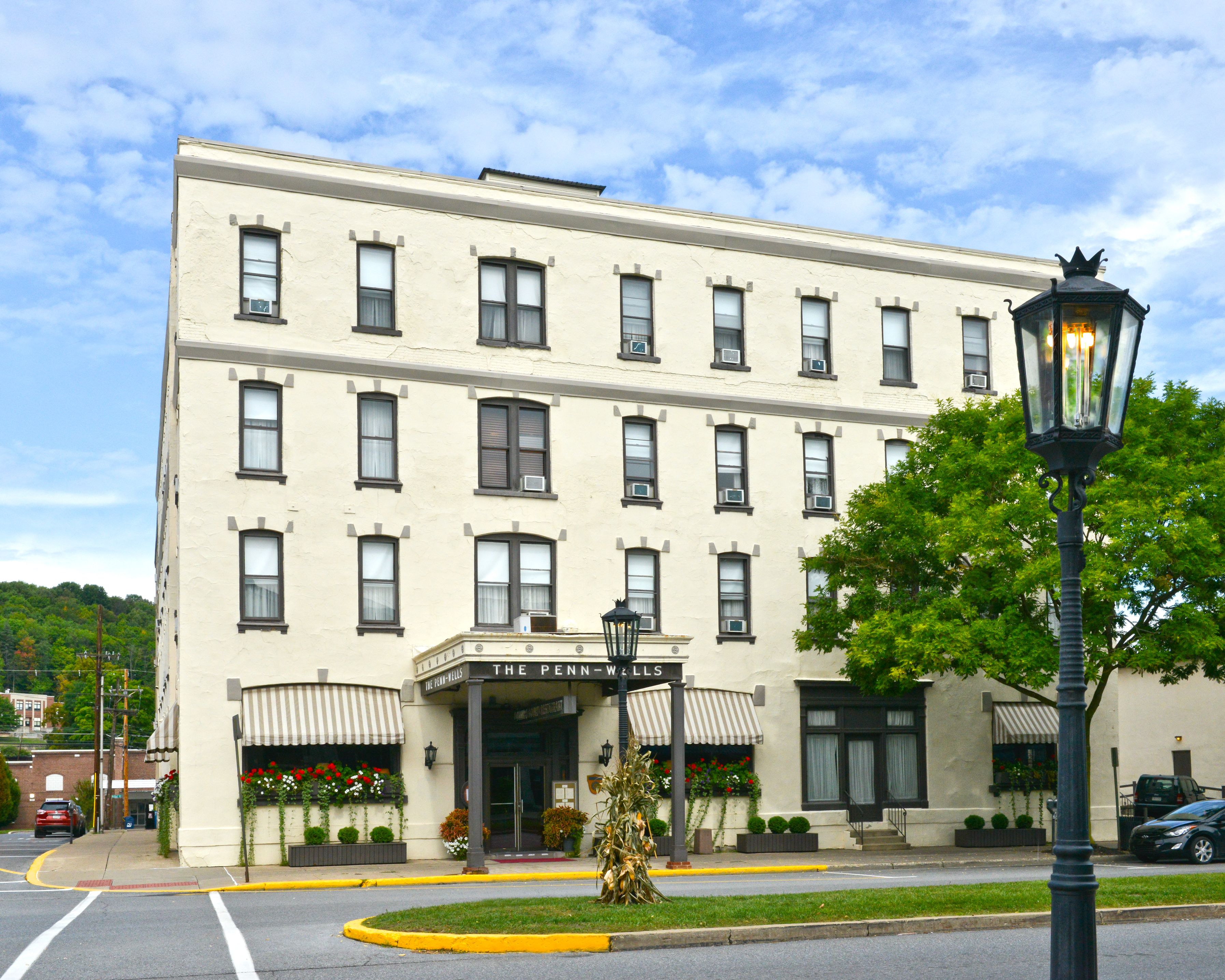 a building with a lamp post and trees