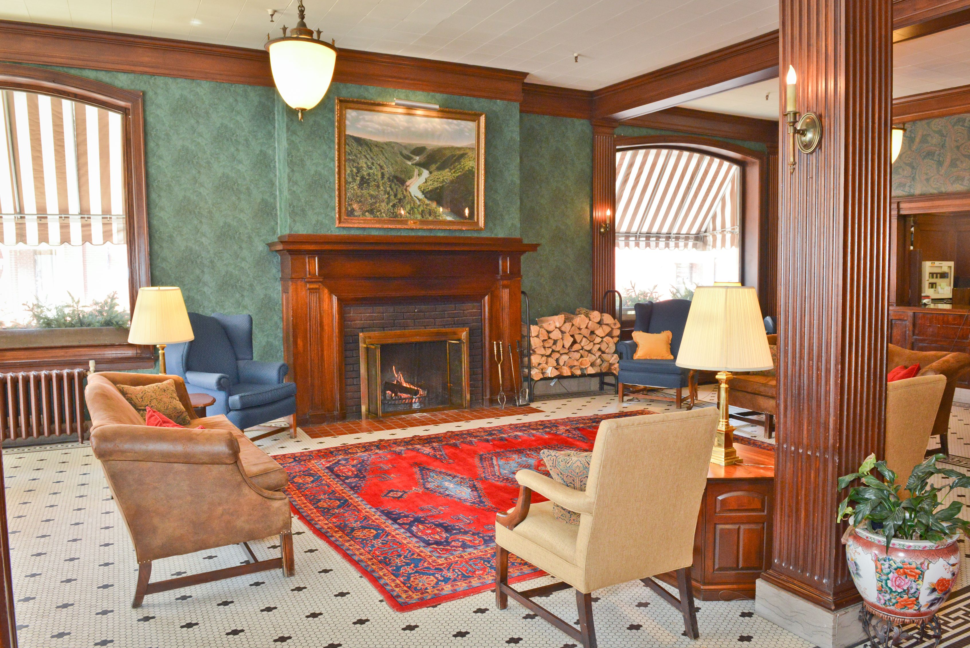 a room with a fireplace and chairs