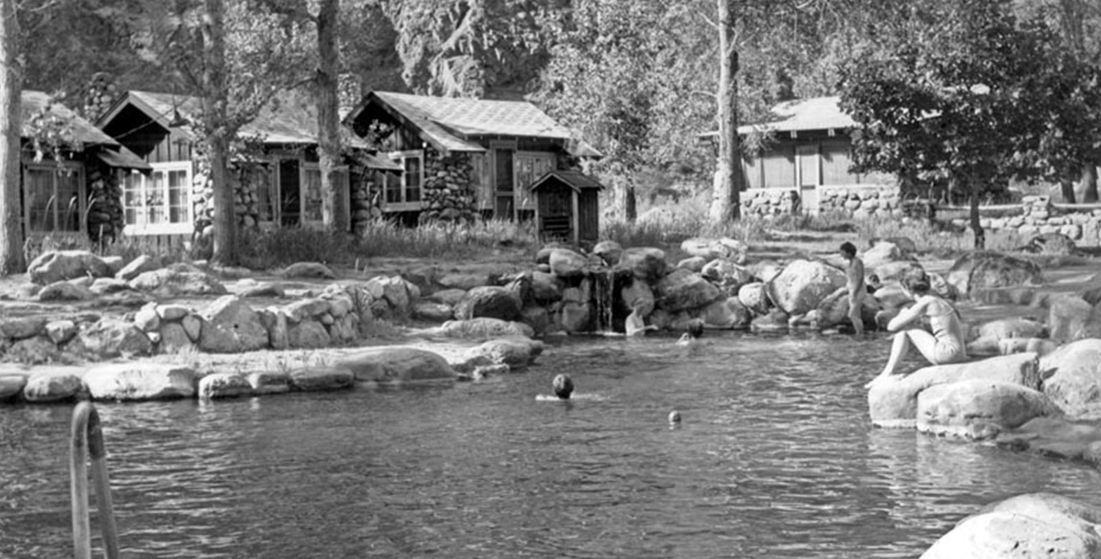 a group of people swimming in a lake
