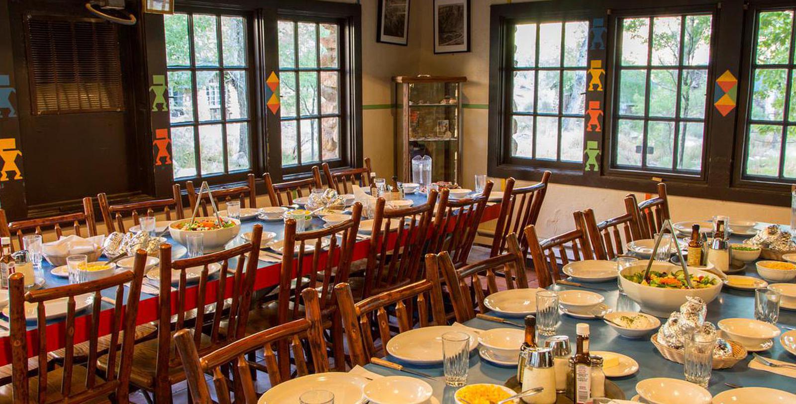 a room with a table set for dinner
