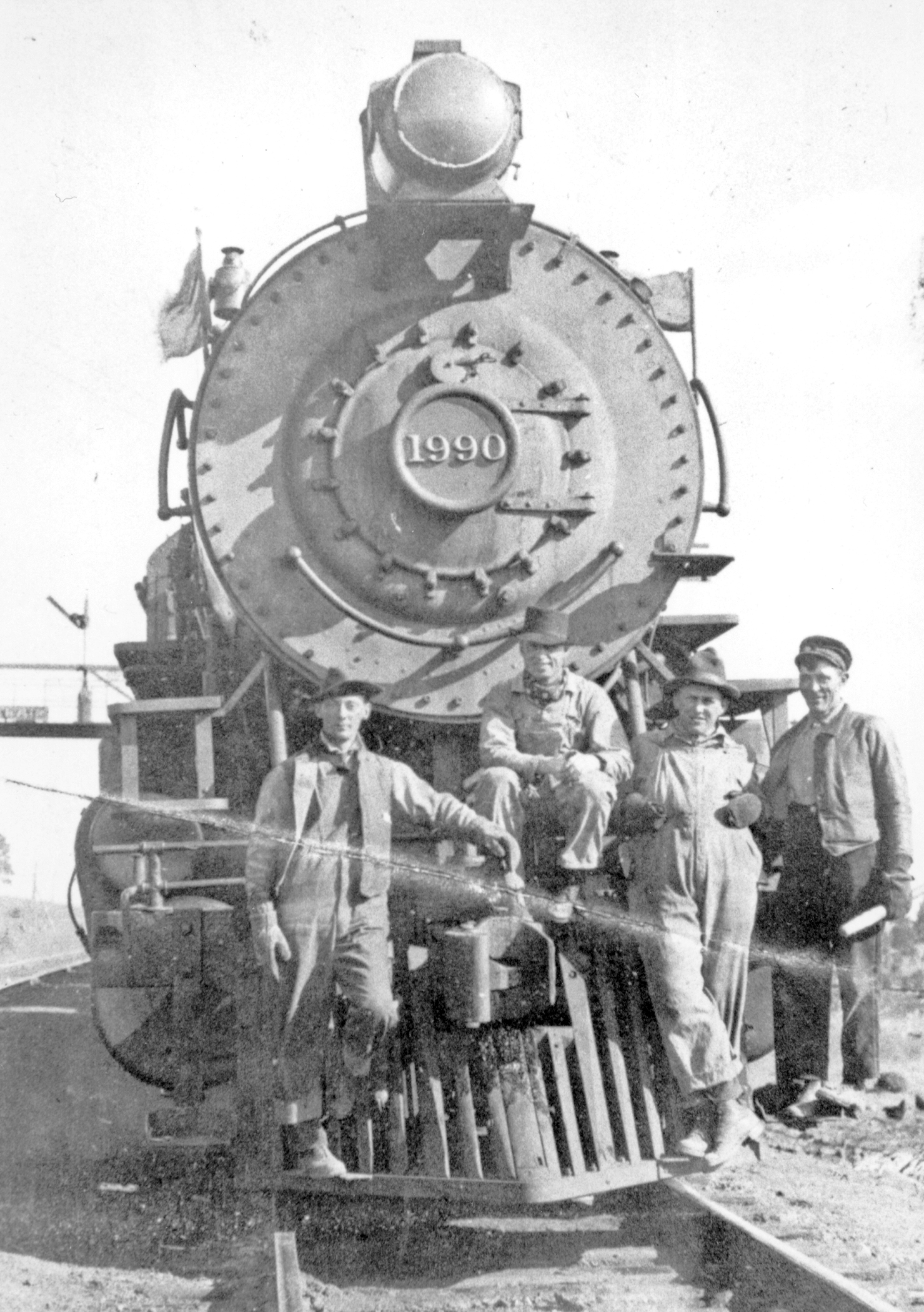 a group of men standing next to a train