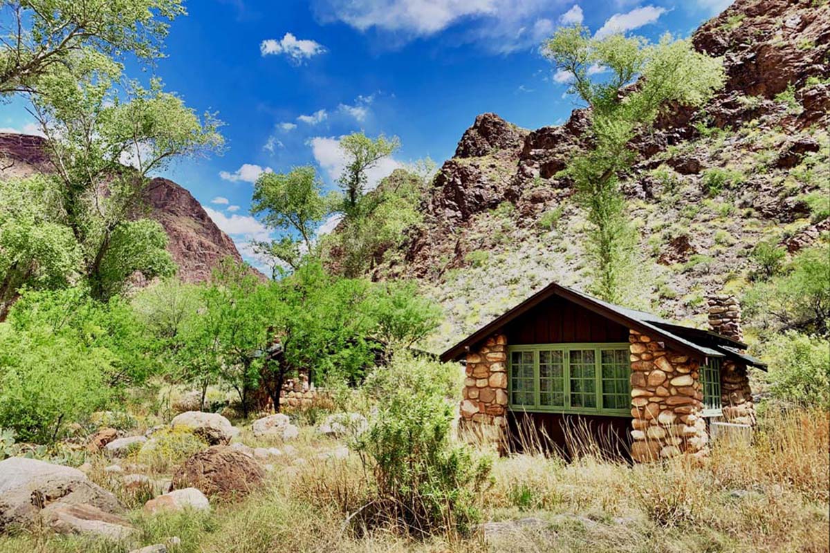 a small stone building in a rocky area