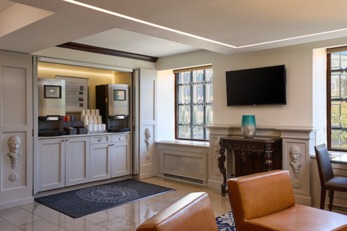 a room with a tv and a coffee machine
